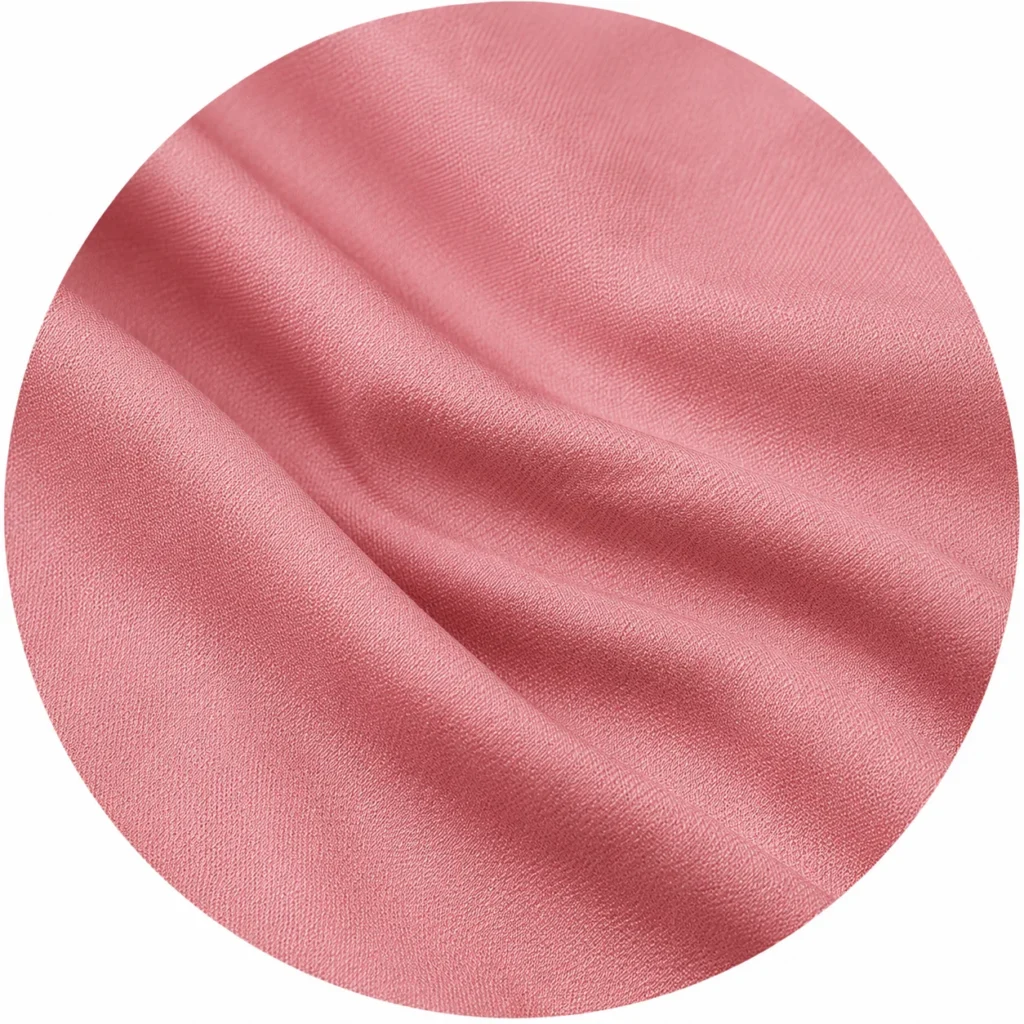 Close-up circular swatch of soft rayon fabric texture used in women's kurtis.